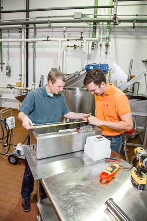 Students working in processing plant.